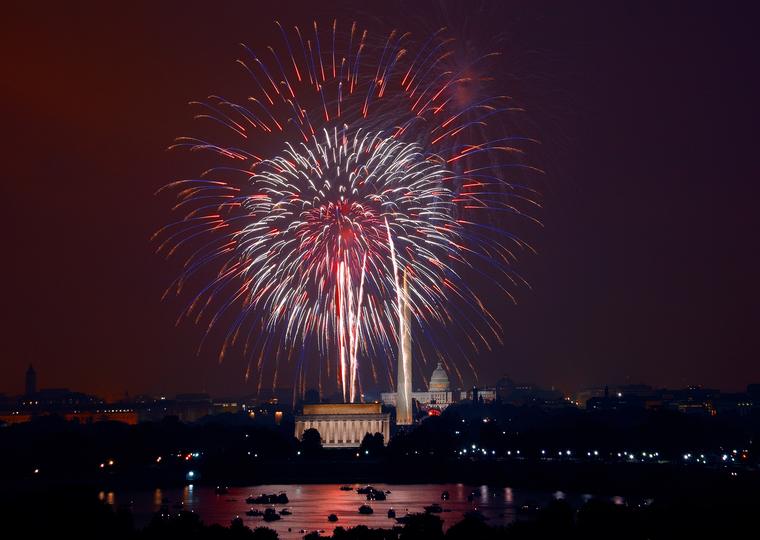 Fireworks over a river and monuments