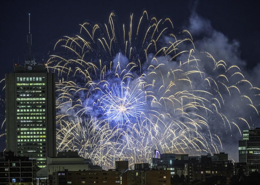 A city skyline under a fireworks display