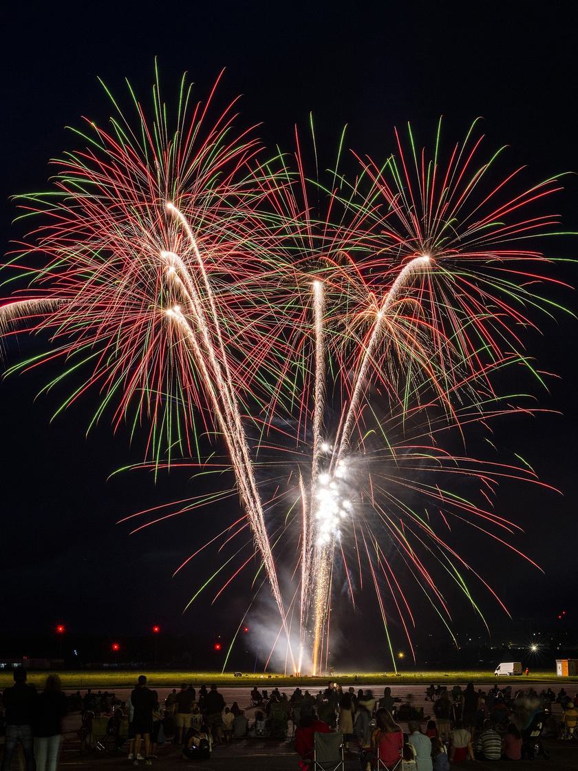 Multi-break shells opening above a crowd at a Classic Fireworks display